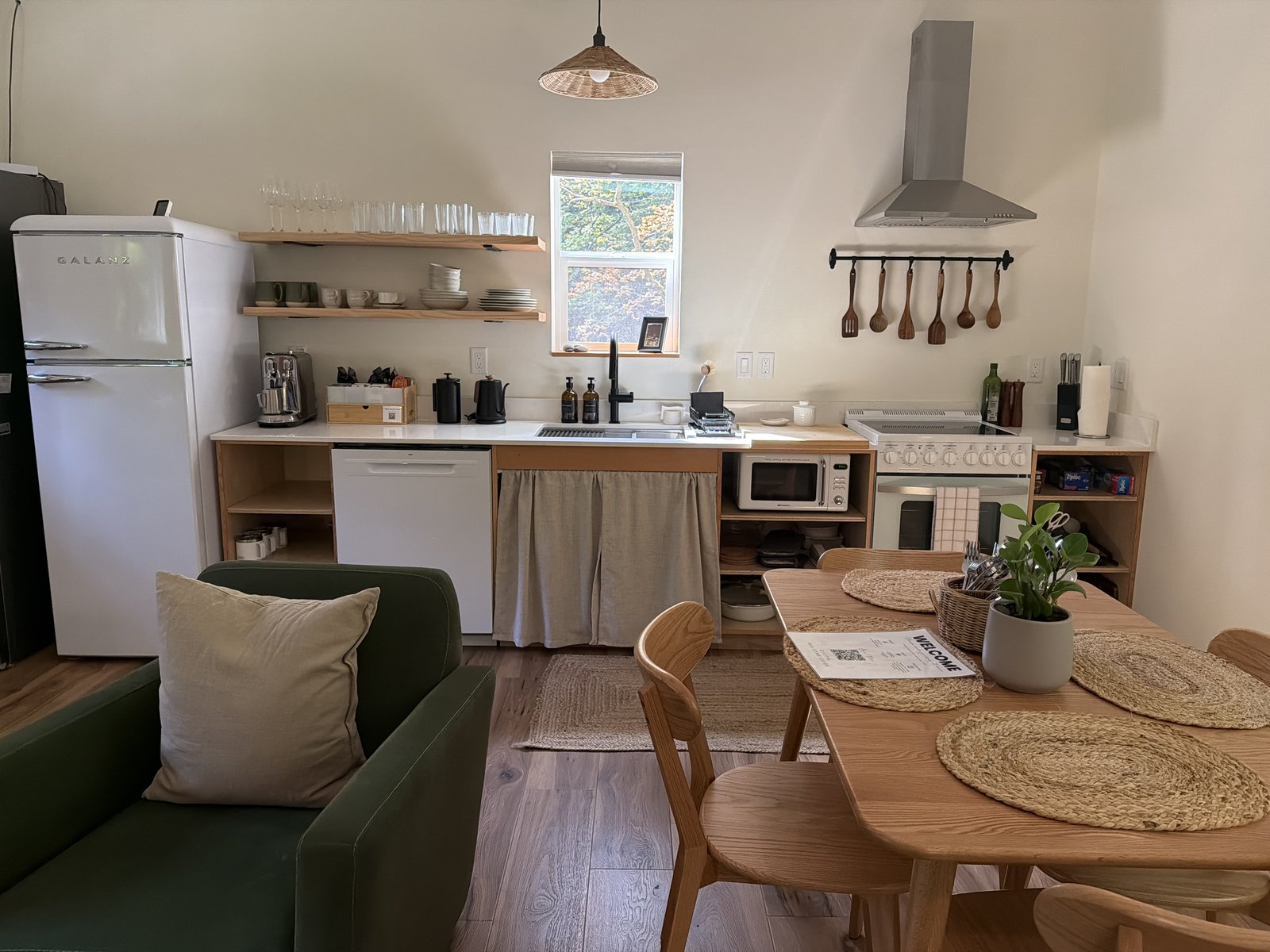 Clean kitchen with white appliances and green accents