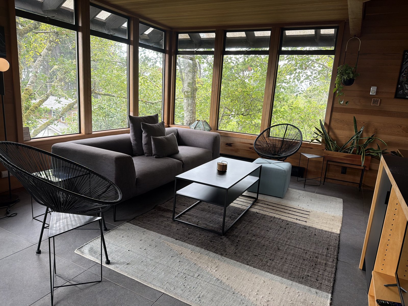 Cozy living room with wood walls and clean furnishings