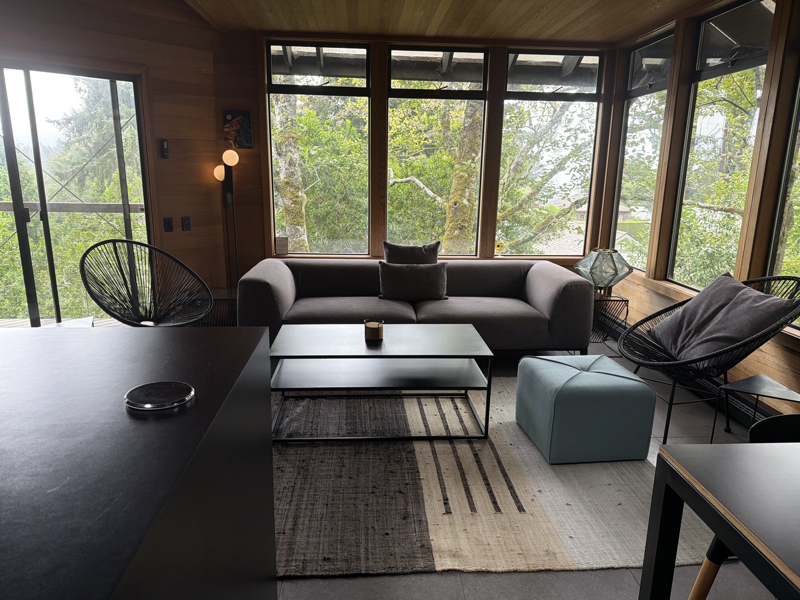 Modern living room with gray sofa and floor-to-ceiling windows