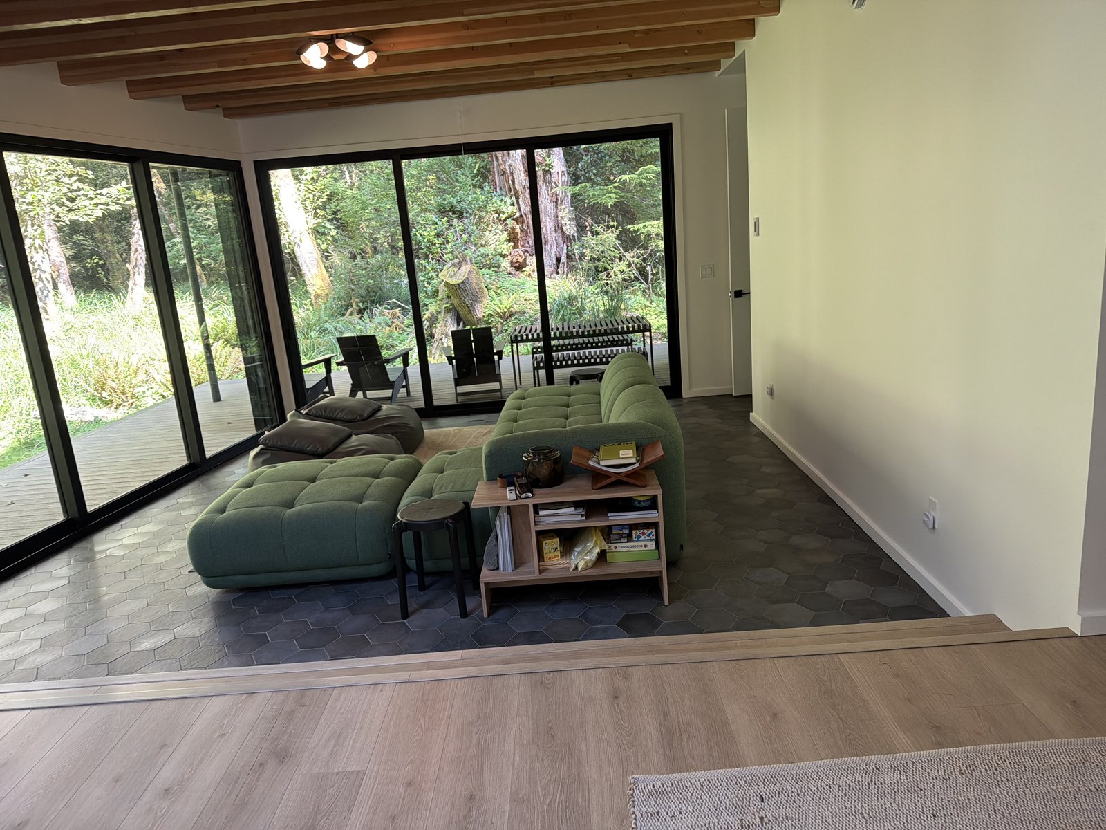 Bright living room with large windows and clean hardwood floors