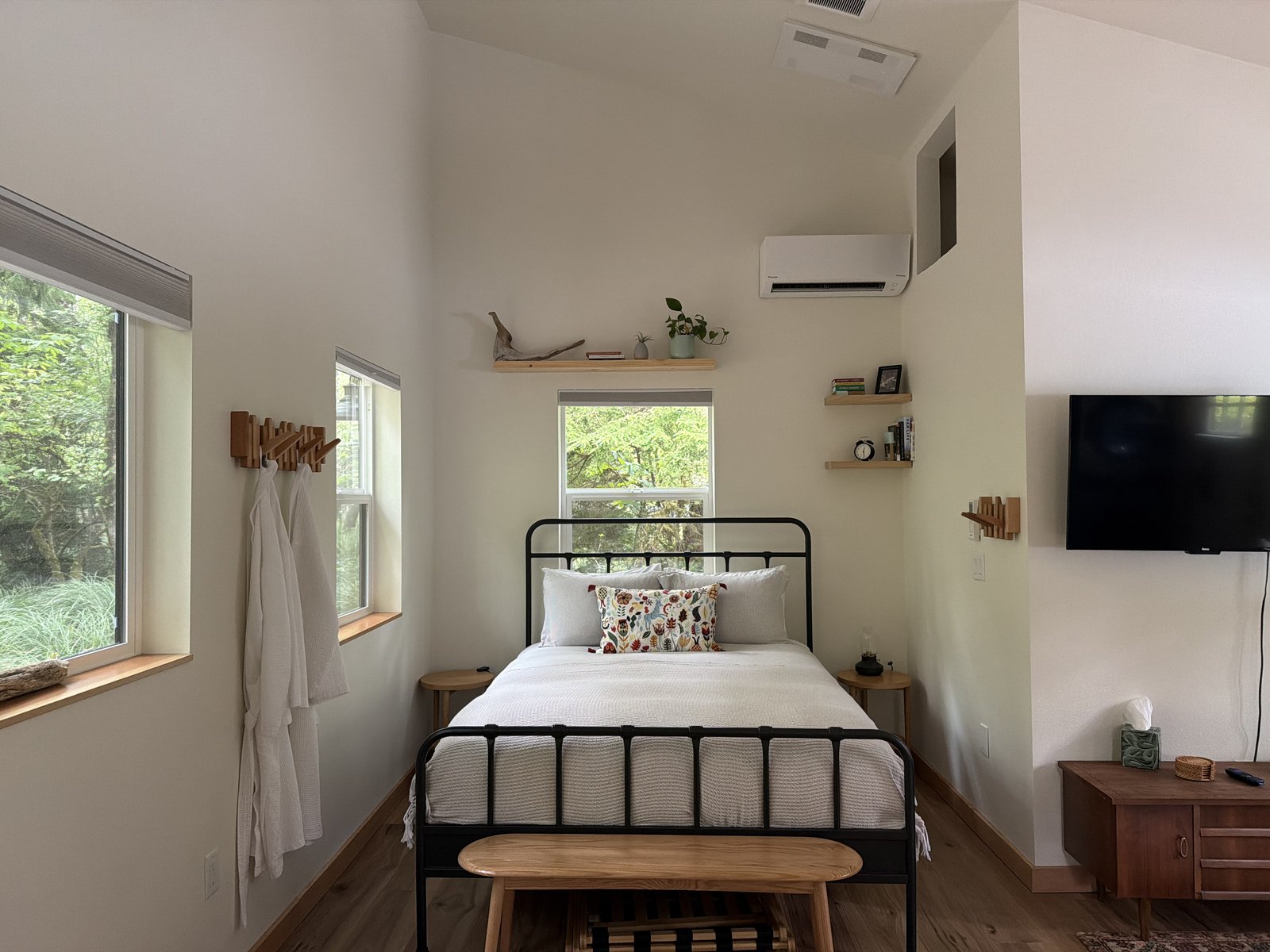 Freshly made bed in a bright coastal bedroom