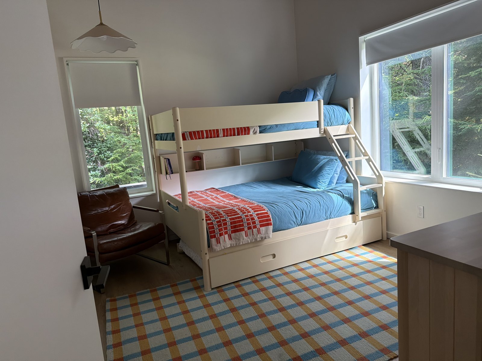 Kids bedroom with bunk bed and tidy plaid rug