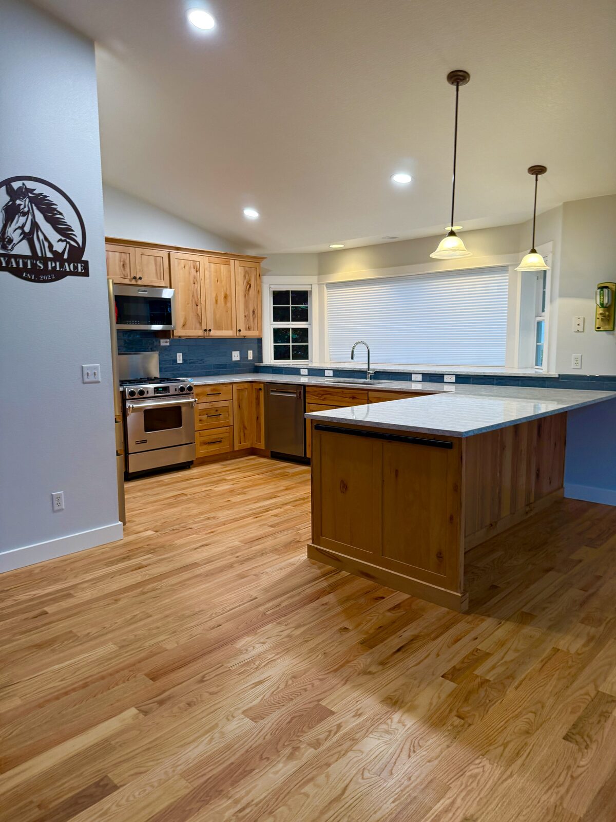 Freshly cleaned kitchen with hickory cabinets and gleaming hardwood floors